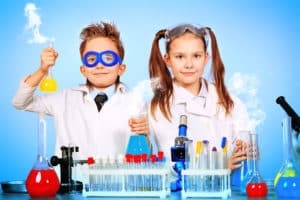 Two children making science experiments. Education.